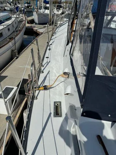 Slide: The Image of 1989 Custom SEA MAID yacht docked at marina, showcasing deck and railing details. - 8
