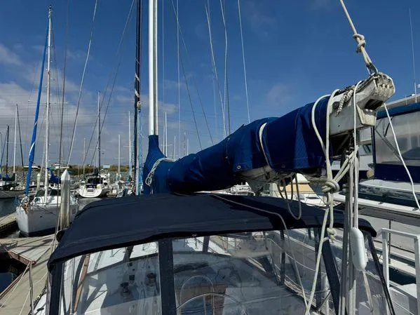 Slide: The Image of Sailboat "SEA MAID" 1989 model docked at marina under clear blue sky. - 9