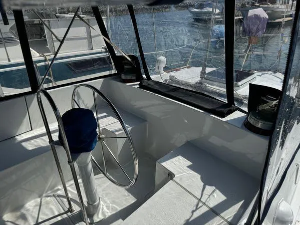Slide: The Image of Cockpit of 1989 Custom SEA MAID boat with steering wheel, marina view. - 11
