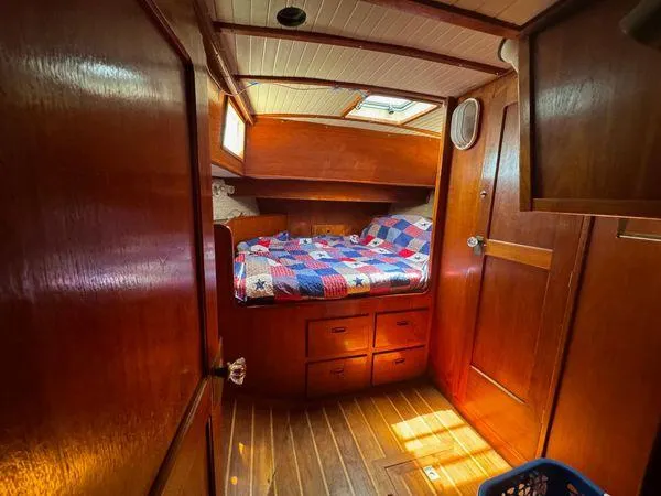 Slide: The Image of Cozy cabin interior of 1989 Custom SEA MAID boat with wooden finish and colorful quilted bed. - 18