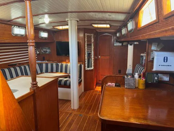 Slide: The Image of Interior of 1989 Custom SEA MAID yacht with wooden furnishings and striped seating. - 2