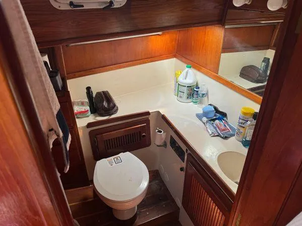 Slide: The Image of Compact 1989 SEA MAID boat bathroom with wooden cabinetry and essential toiletries. - 23
