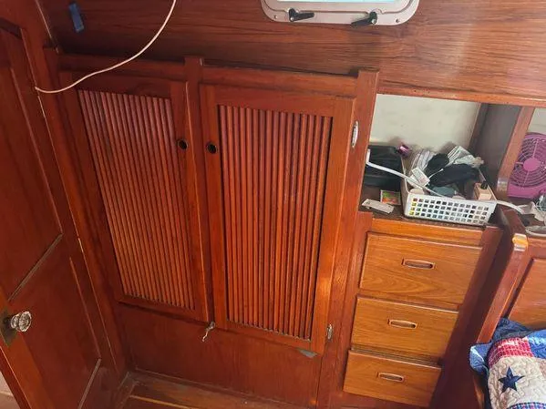 Slide: The Image of Wooden cabin interior with storage cabinets and drawers on a 1989 Custom SEA MAID boat. - 24
