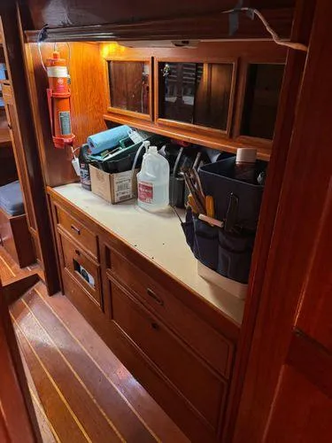 Slide: The Image of Interior of 1989 Custom SEA MAID boat with wooden cabinetry and storage area. - 25