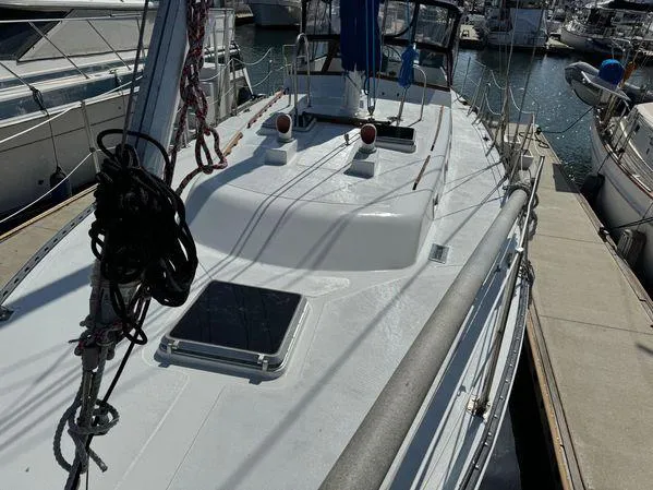 Slide: The Image of Sailboat "SEA MAID" 1989 model docked at marina, featuring clean deck and rigging. - 26