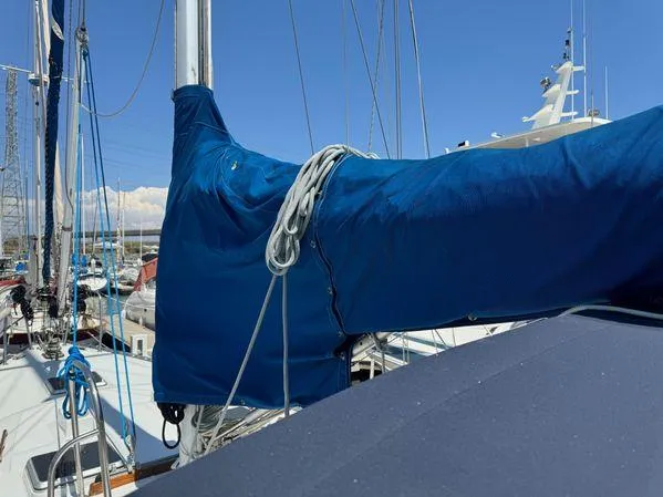 Slide: The Image of Sailboat SEA MAID 1989 with blue sail cover docked in marina. - 32