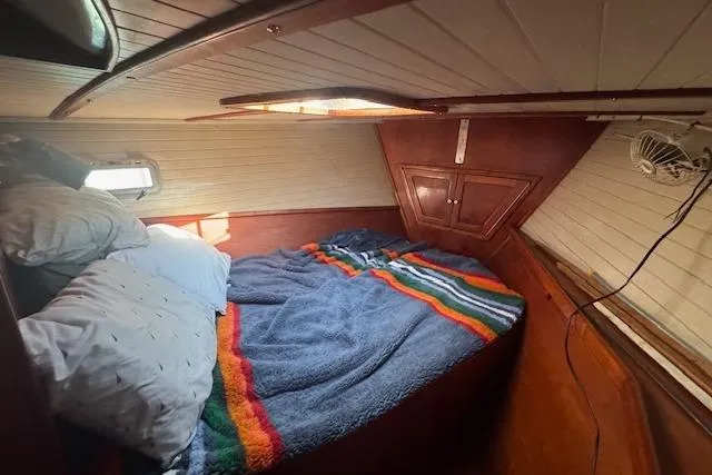 Slide: The Image of Cozy cabin interior of 1989 Custom SEA MAID with colorful bedding and wooden paneling. - 44