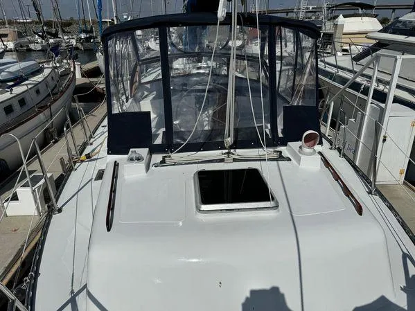 Slide: The Image of Custom 1989 SEA MAID yacht docked at marina, featuring spacious deck and clear canopy. - 7