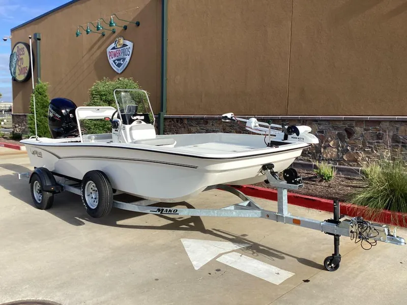 Slide: The Image of 2025 Mako Pro Skiff 17 CC boat on trailer, parked outdoors. - 2