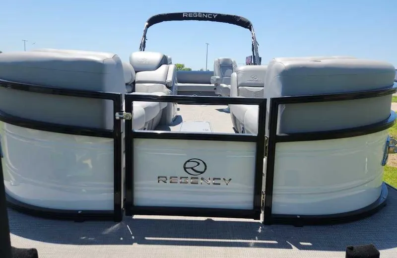 Slide: The Image of 2024 Regency 250 DL3 pontoon boat with sleek seating and open deck design. - 10