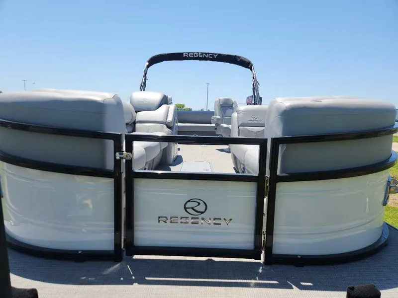 Slide: The Image of 2024 Regency 250 DL3 pontoon boat with spacious seating and sleek design. - 14