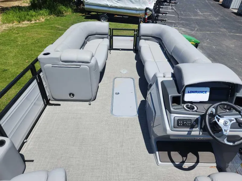 Slide: The Image of 2024 Regency 250 DL3 pontoon boat interior with plush seating and modern dashboard. - 15