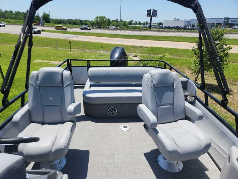 Slide: The Image of 2024 Regency 250 DL3 pontoon boat with plush seating and modern design. - 17