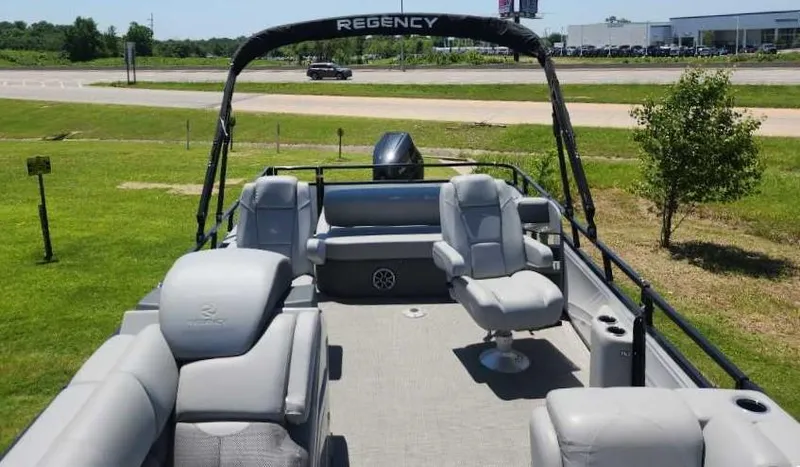 Slide: The Image of 2024 Regency 250 DL3 pontoon boat with spacious seating and modern design. - 5