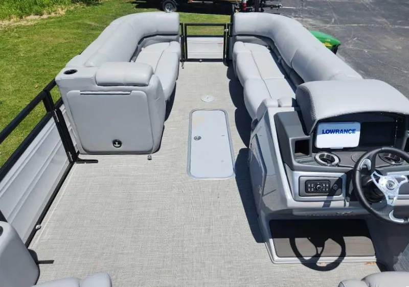 Slide: The Image of 2024 Regency 250 DL3 pontoon boat interior with spacious seating and modern dashboard. - 9