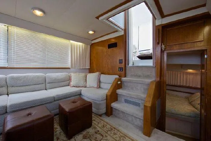 Slide: The Image of Luxurious interior of 1994 Carver 390 yacht with cozy seating and elegant wood finishes. - 12
