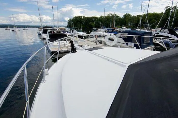 Slide: The Image of 1994 Carver 390 yacht docked at a marina with other boats. - 5