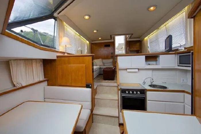 Slide: The Image of Interior of a 1994 Carver 390 yacht with kitchen and seating area. - 7