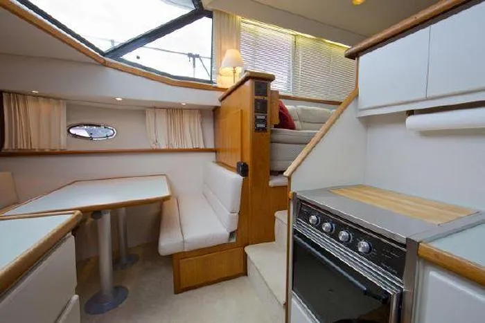 Slide: The Image of Interior of a 1994 Carver 390 yacht with dining area and kitchen. - 9