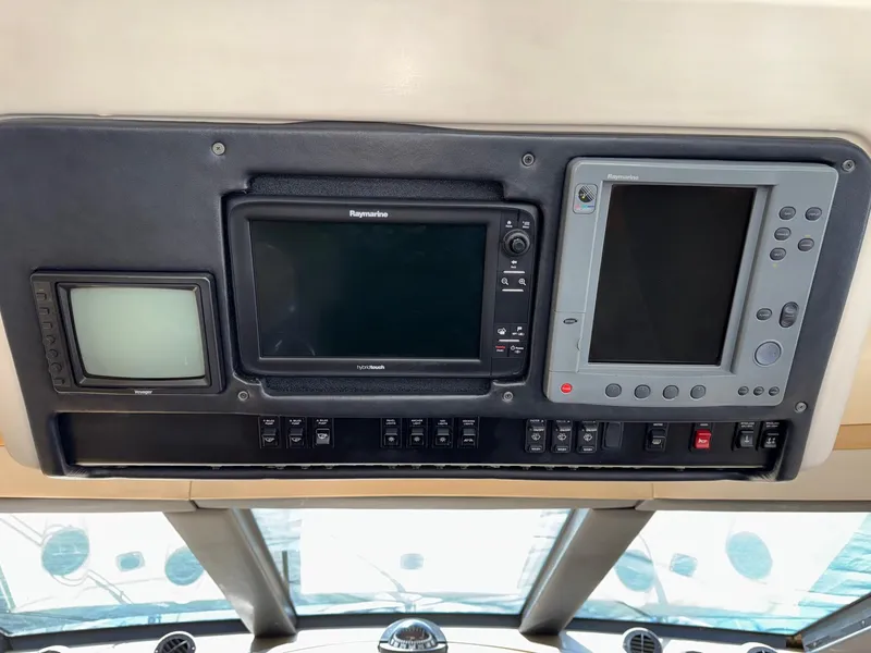 Slide: The Image of Control panel of 2002 Carver 570 Voyager Pilothouse with navigation screens. - 13