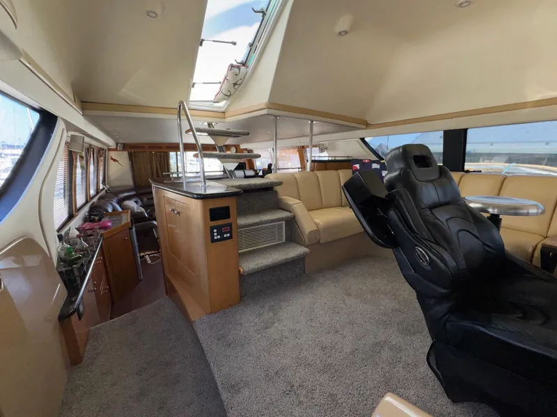 Slide: The Image of Luxurious interior of a 2002 Carver 570 Voyager Pilothouse yacht with plush seating and modern amenities. - 20