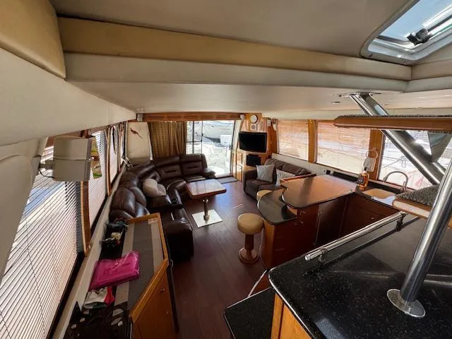 Slide: The Image of Luxurious interior of 2002 Carver 570 Voyager Pilothouse yacht with leather seating and modern amenities. - 22