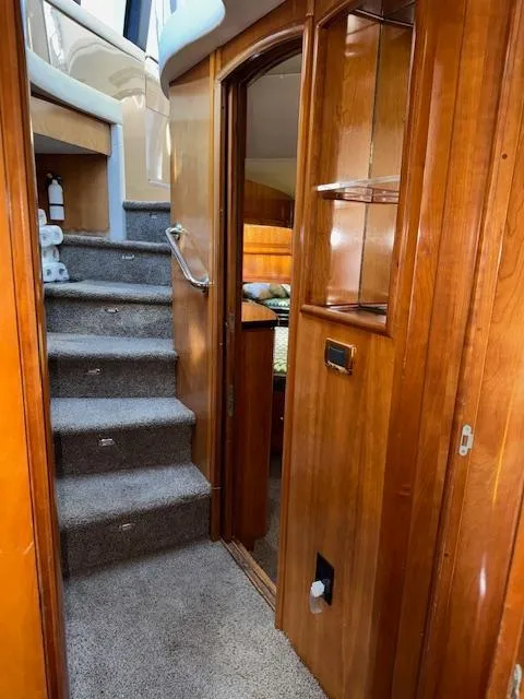Slide: The Image of Interior of 2002 Carver 570 Voyager Pilothouse with wooden finishes and carpeted stairs. - 29