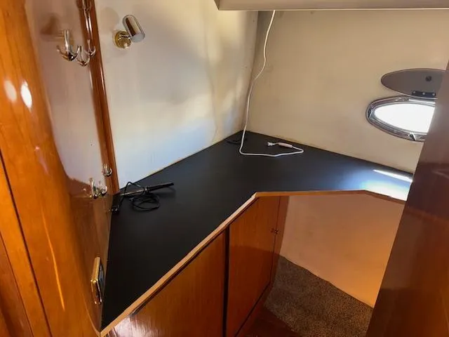 Slide: The Image of 2002 Carver 570 Voyager Pilothouse interior with wooden cabinetry and countertop. - 32