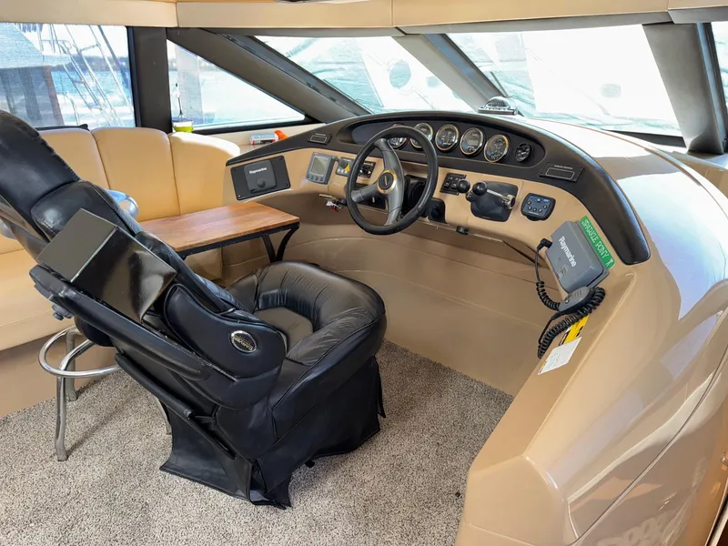Slide: The Image of Pilothouse interior of 2002 Carver 570 Voyager, featuring steering wheel and control panel. - 4