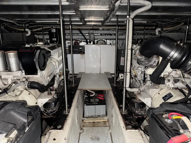 Slide: The Image of Engine room of 2002 Carver 570 Voyager Pilothouse with dual engines and mechanical components. - 42