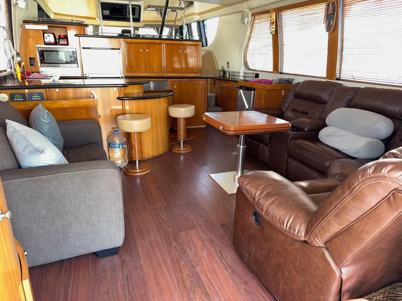 Slide: The Image of Luxurious interior of 2002 Carver 570 Voyager Pilothouse with leather seating and modern kitchen. - 6