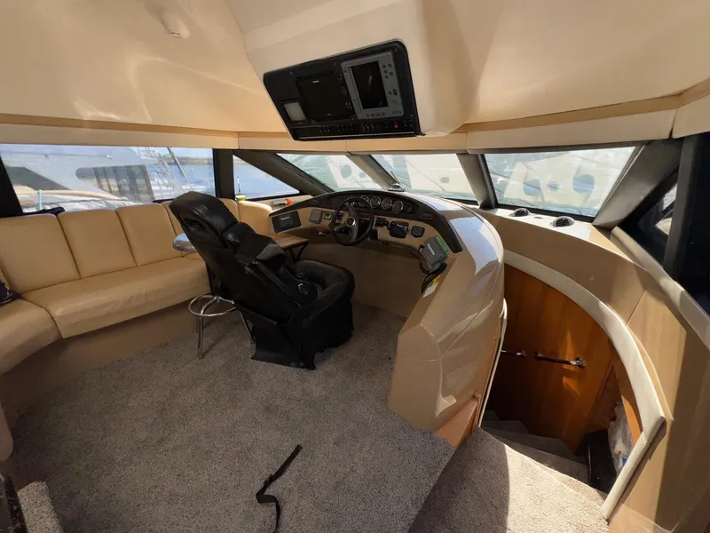 Slide: The Image of Pilothouse interior of 2002 Carver 570 Voyager, featuring helm and seating area. - 14