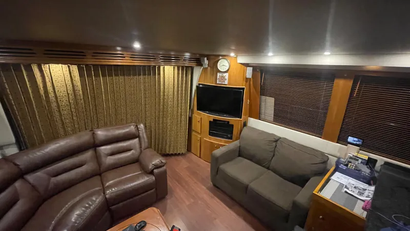 Slide: The Image of Luxurious interior of 2002 Carver 570 Voyager Pilothouse with leather seating and entertainment center. - 16