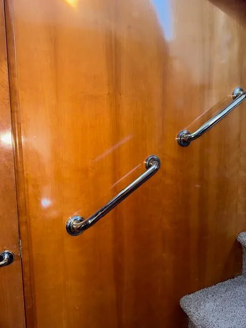 Slide: The Image of Wooden interior with metal handrails on a 2002 Carver 570 Voyager Pilothouse. - 30