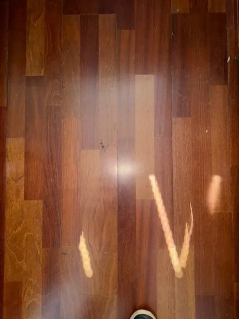 Slide: The Image of Polished wooden floor with light reflections, possibly inside a 2002 Carver 570 Voyager Pilothouse. - 34