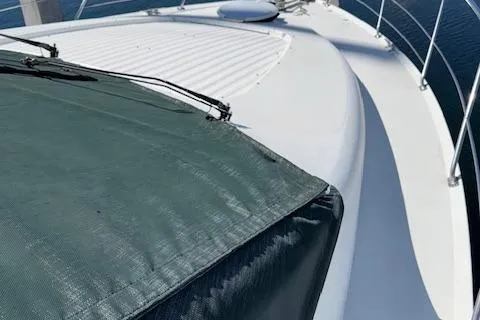 Slide: The Image of 2002 Carver 570 Voyager Pilothouse deck with green cover and railing. - 39