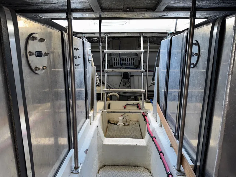 Slide: The Image of 2002 Carver 570 Voyager Pilothouse engine room with metal tanks and ladder. - 43
