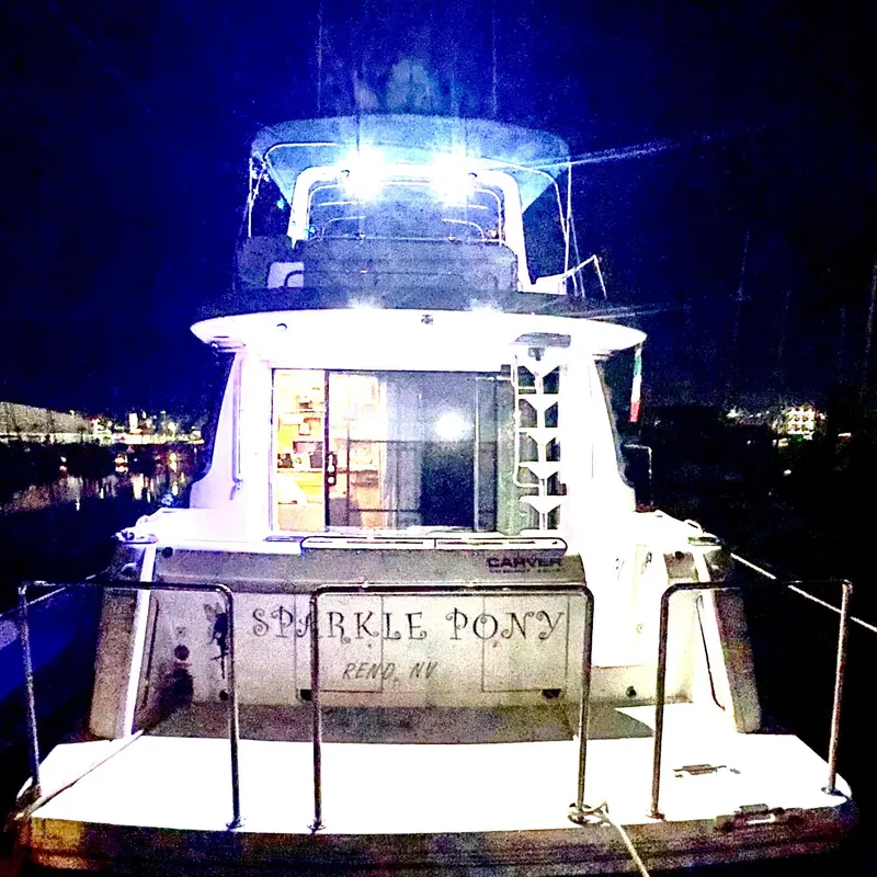 Slide: The Image of 2002 Carver 570 Voyager Pilothouse yacht named "Sparkle Pony" illuminated at night. - 44