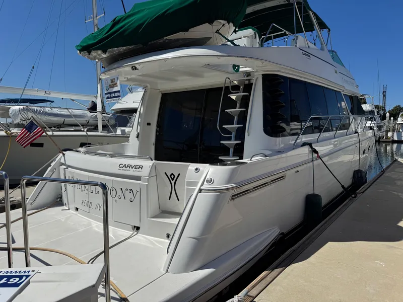 Slide: The Image of 2002 Carver 570 Voyager Pilothouse yacht docked at marina, rear view. - 45