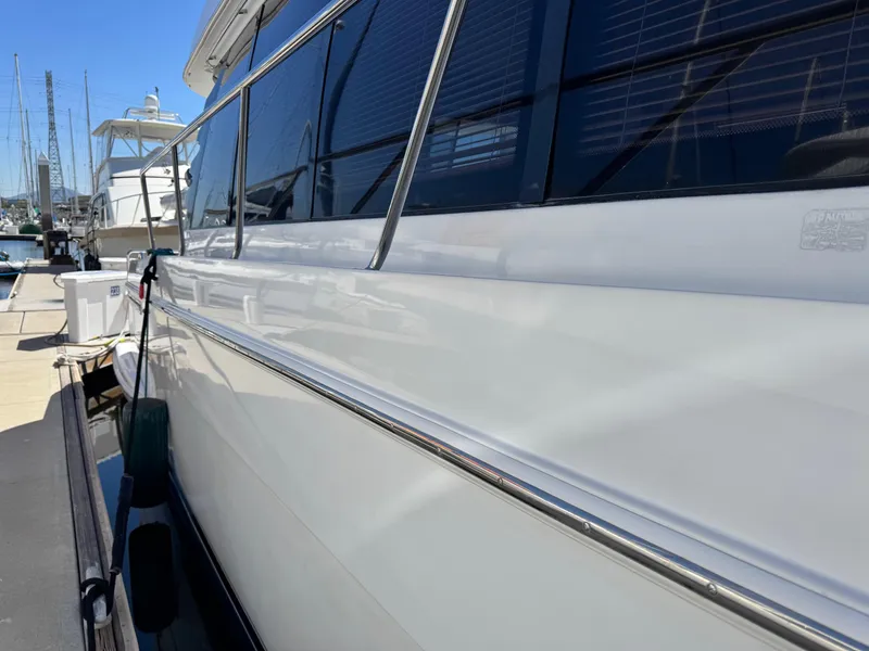 Slide: The Image of 2002 Carver 570 Voyager Pilothouse yacht docked at marina, side view. - 47