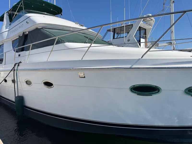 Slide: The Image of 2002 Carver 570 Voyager Pilothouse yacht docked at marina, side view. - 9