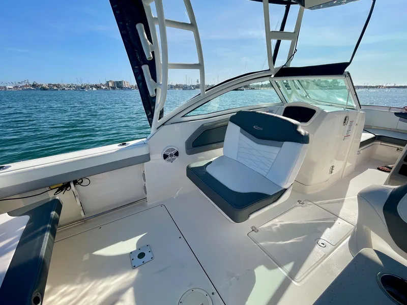 Slide: The Image of 2021 Robalo 247 Dual Console boat interior with seating, on a sunny day by the water. - 11