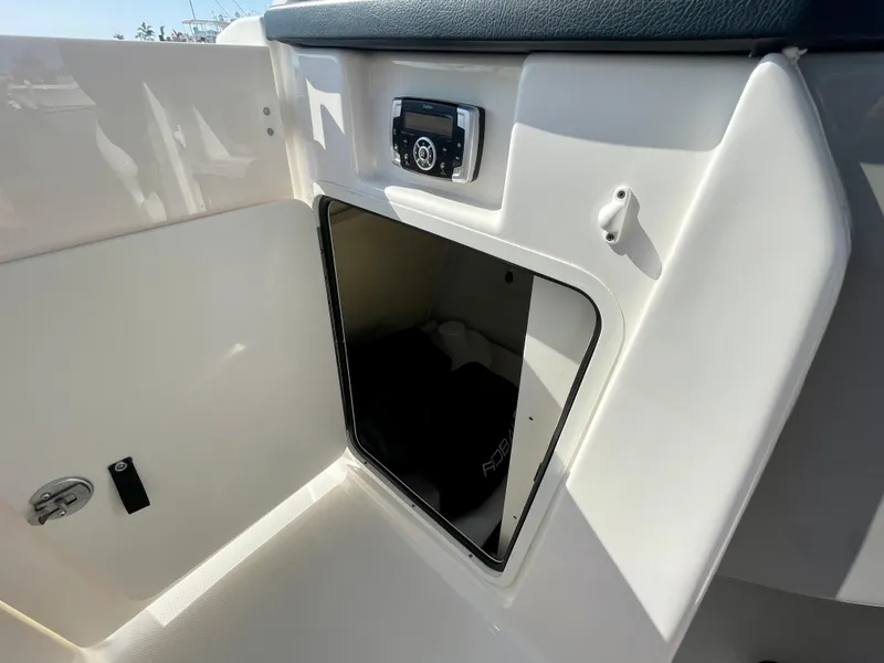 Slide: The Image of 2021 Robalo 247 Dual Console boat interior storage compartment with sleek design and modern features. - 22