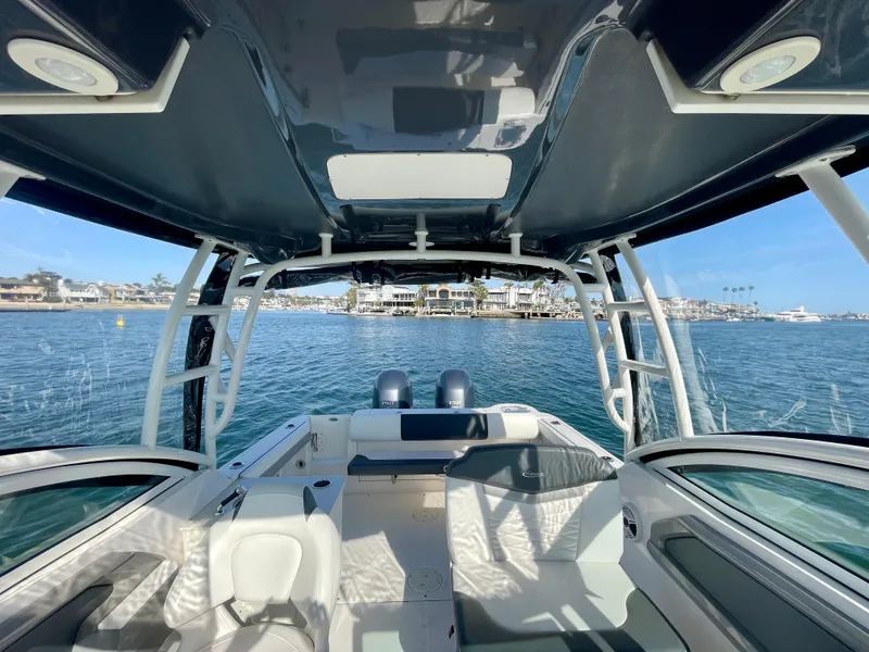 Slide: The Image of 2021 Robalo 247 Dual Console boat interior with ocean view and modern seating. - 24