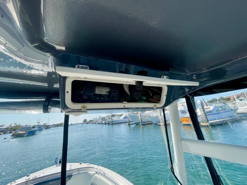 Slide: The Image of 2021 Robalo 247 Dual Console boat interior with control panel, docked in marina. - 32