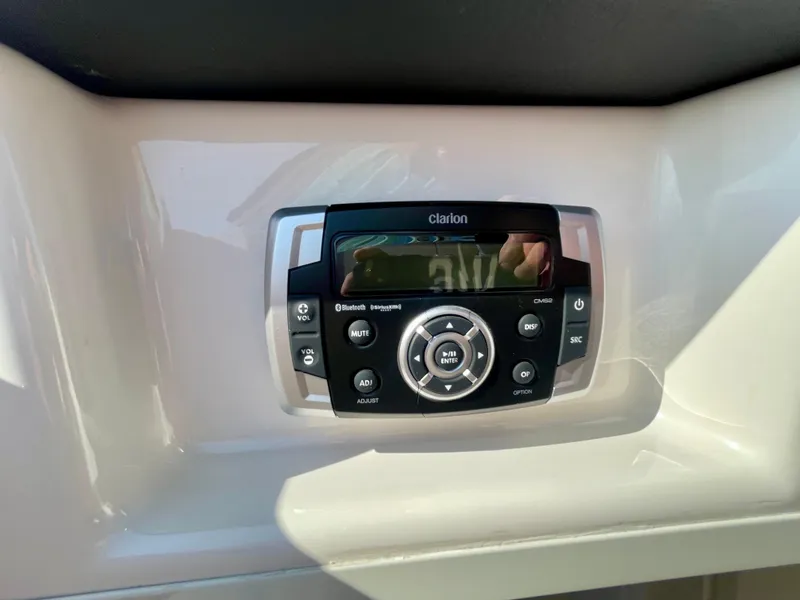 Slide: The Image of Clarion audio system on 2021 Robalo 247 Dual Console boat dashboard. - 34