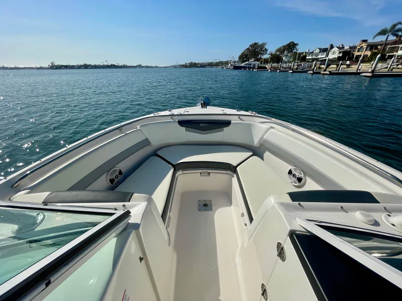 Slide: The Image of 2021 Robalo 247 Dual Console boat on calm water, sunny day, spacious seating. - 8