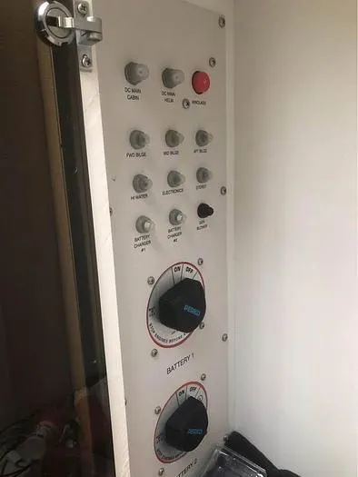 Slide: The Image of Control panel of a 2000 Wellcraft 3200 boat with various switches and dials. - 12