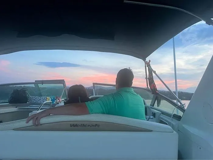 Slide: The Image of Couple enjoying sunset on a 2000 Wellcraft 3200 boat. - 13