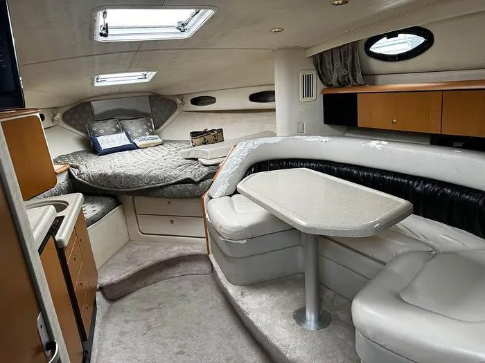 Slide: The Image of Interior of a 2000 Wellcraft 3200 boat with cozy seating and sleeping area. - 15